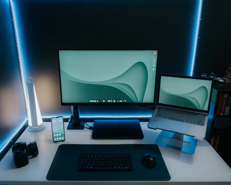 Clean desk setup with laptop stand and monitor